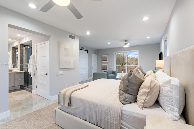 bedroom with connected bathroom, a barn door, and ceiling fan