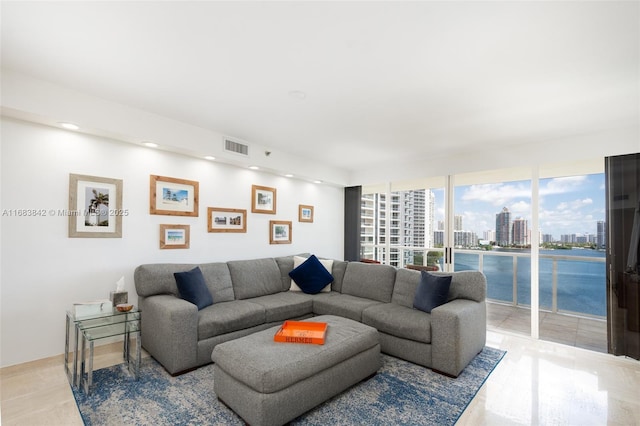 living room with visible vents, a city view, and recessed lighting