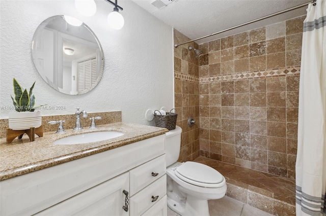 bathroom with vanity, toilet, walk in shower, and a textured ceiling