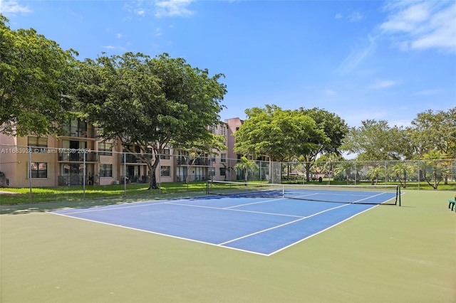 view of tennis court with basketball hoop