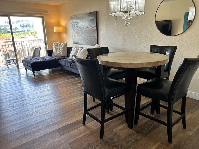 dining room featuring a notable chandelier and wood-type flooring