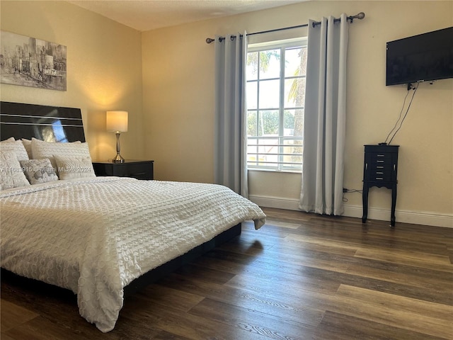 bedroom with dark wood-type flooring