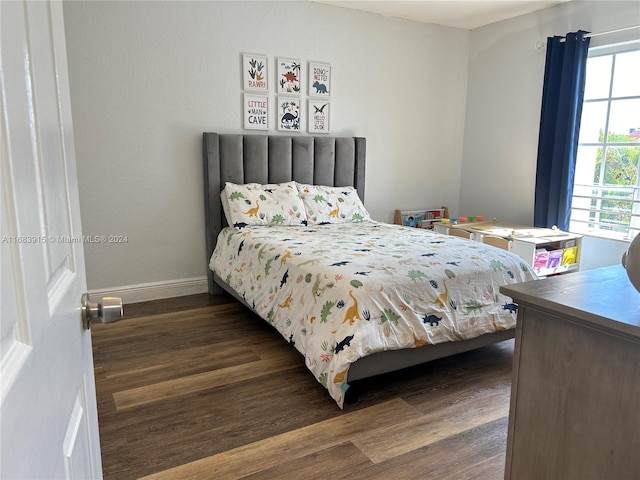 bedroom with dark wood-type flooring