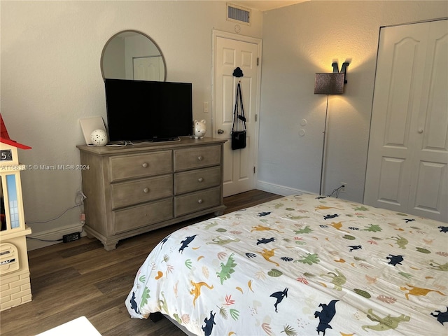 bedroom with a closet and dark hardwood / wood-style flooring