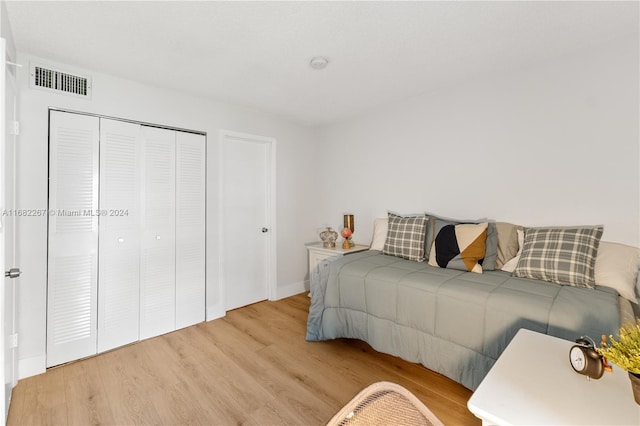 bedroom featuring light hardwood / wood-style floors and a closet