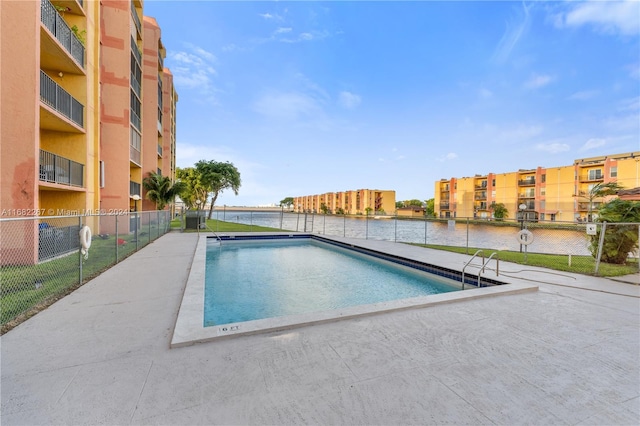 view of swimming pool with a water view