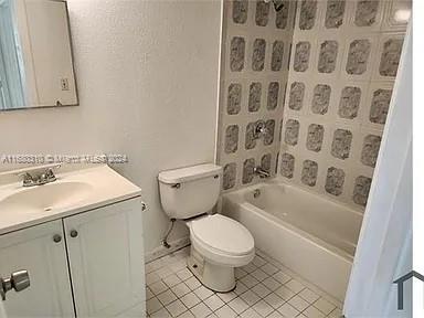 full bathroom with vanity, toilet, tile patterned floors, and tub / shower combination