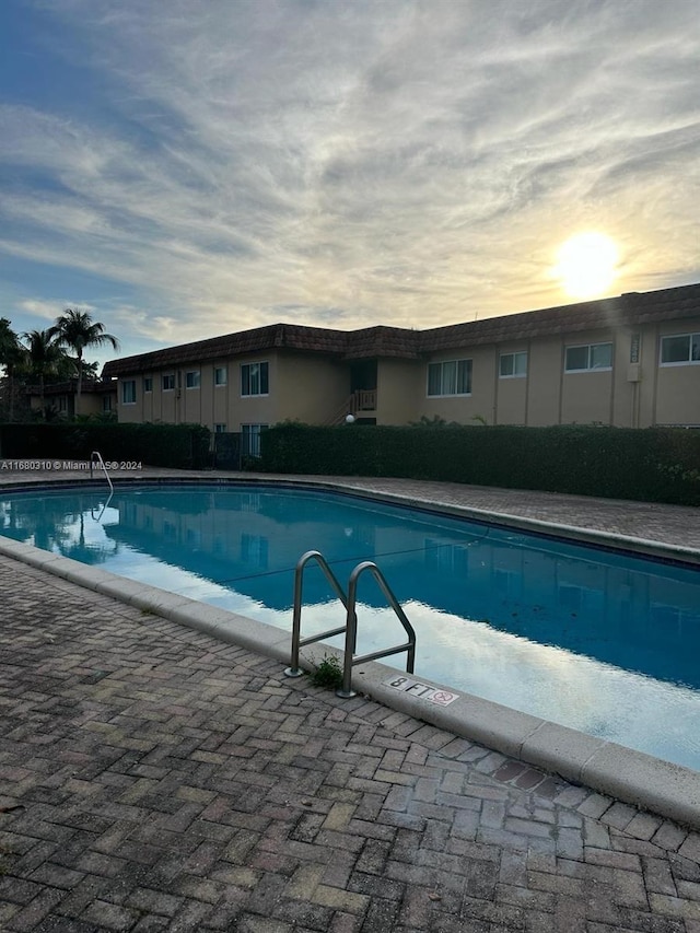 view of pool at dusk