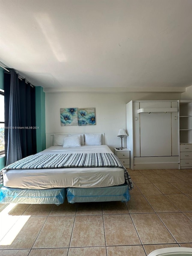 unfurnished bedroom featuring tile patterned flooring