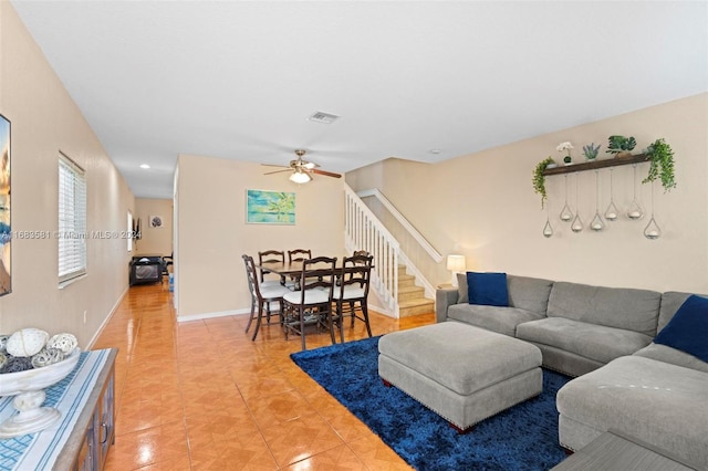 tiled living room featuring ceiling fan