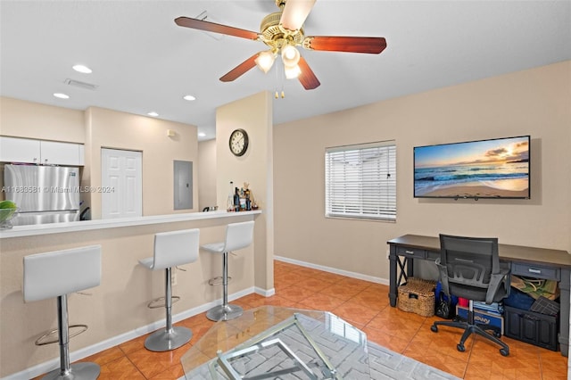 tiled home office featuring electric panel and ceiling fan