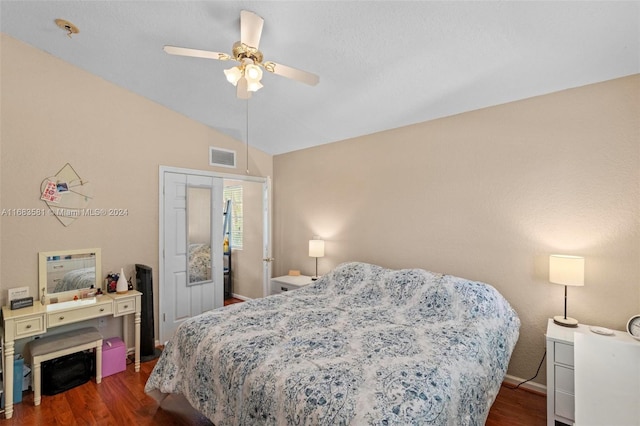 bedroom with dark wood-type flooring, vaulted ceiling, and ceiling fan