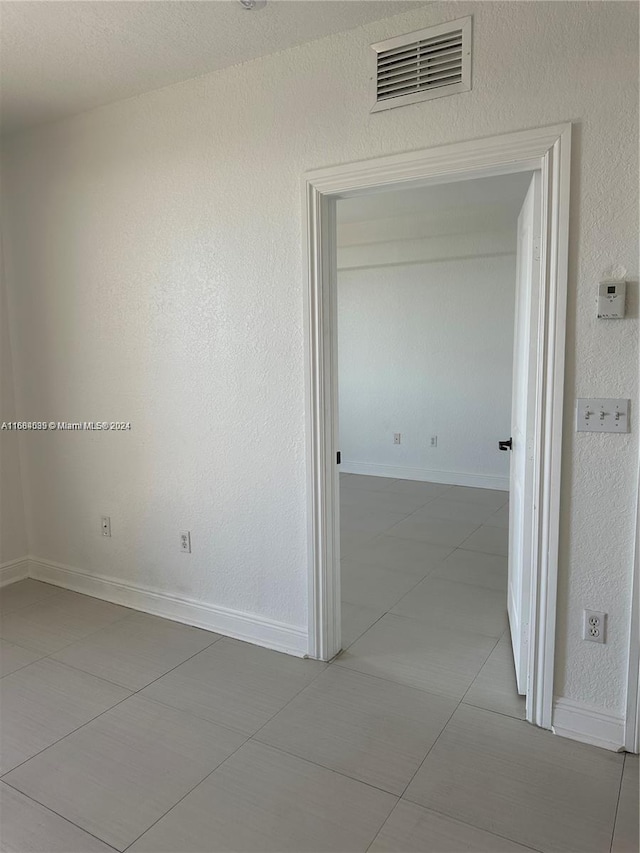 corridor with tile patterned flooring