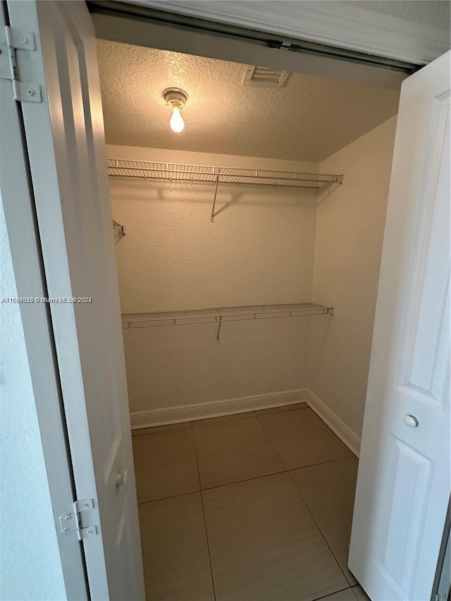 spacious closet featuring tile patterned floors