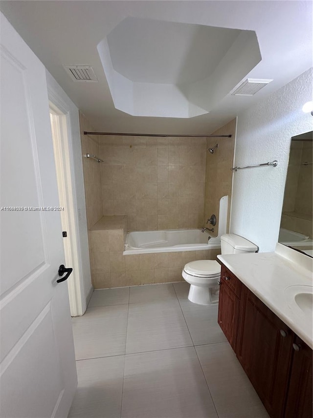 full bathroom with toilet, tiled shower / bath combo, vanity, and tile patterned flooring