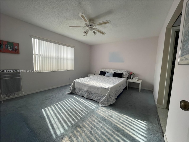 bedroom with carpet flooring, a textured ceiling, and ceiling fan