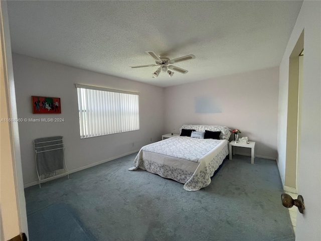 carpeted bedroom with ceiling fan and a textured ceiling