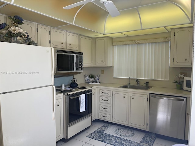 kitchen featuring sink, light tile patterned flooring, and white appliances