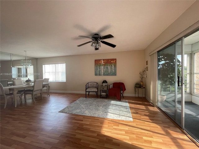 interior space with hardwood / wood-style flooring and ceiling fan with notable chandelier