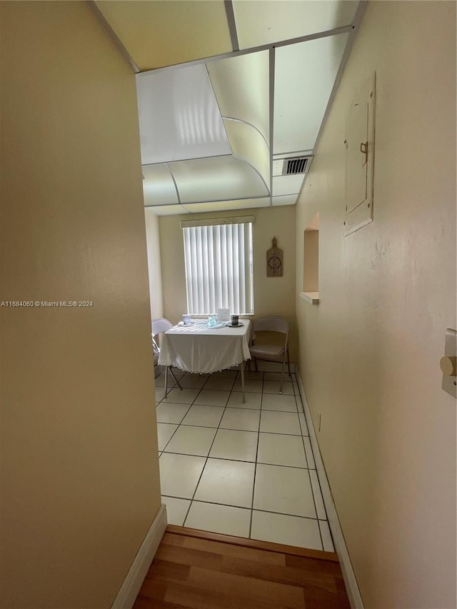 corridor featuring light tile patterned floors