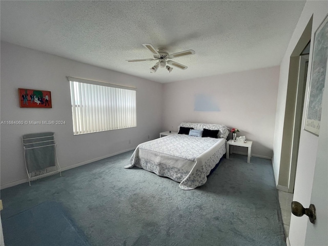 bedroom featuring ceiling fan, a textured ceiling, and carpet floors