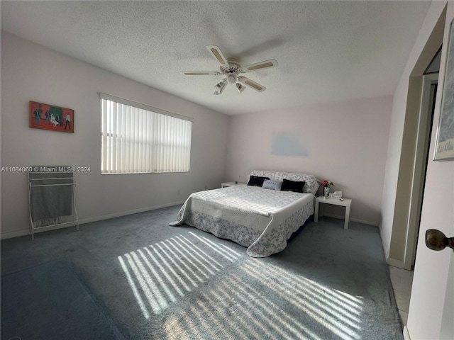 bedroom featuring carpet, ceiling fan, and a textured ceiling