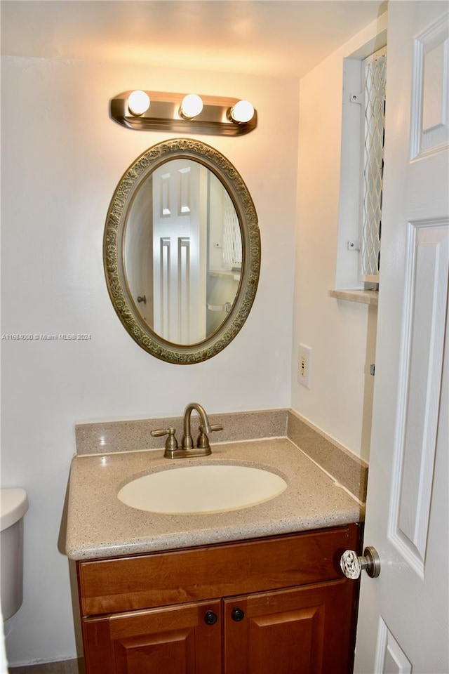 bathroom with vanity and toilet