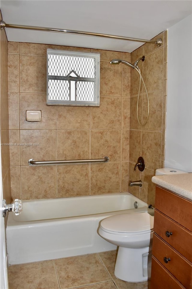 full bathroom with vanity, tiled shower / bath combo, toilet, and tile patterned flooring