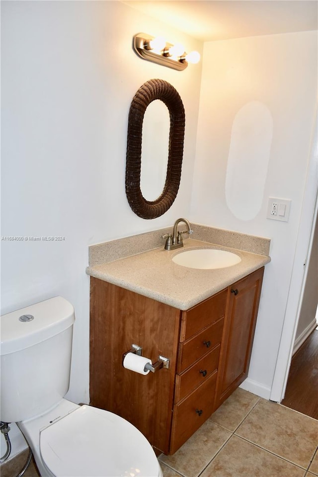 bathroom featuring vanity, toilet, and tile patterned floors