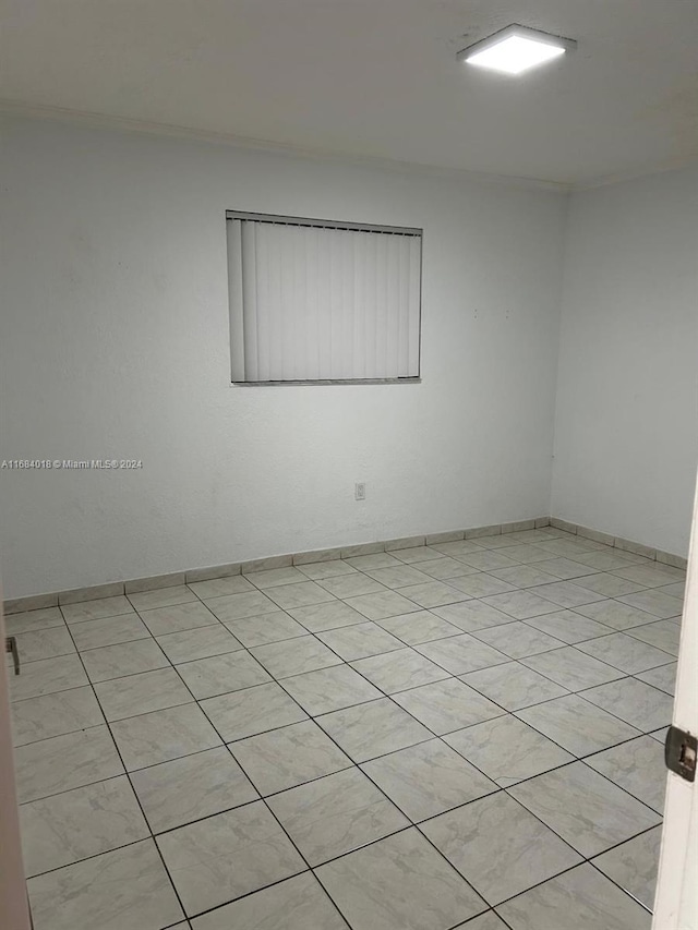 unfurnished room with light tile patterned flooring