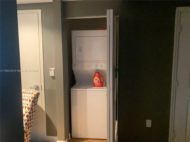 laundry area featuring stacked washer / dryer