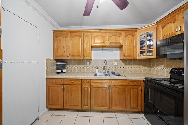 kitchen featuring ceiling fan, black appliances, sink, light tile patterned flooring, and ornamental molding