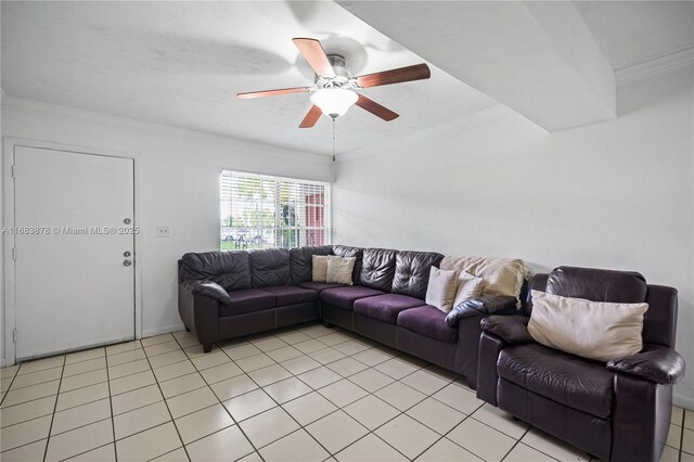 tiled living room with ceiling fan and crown molding