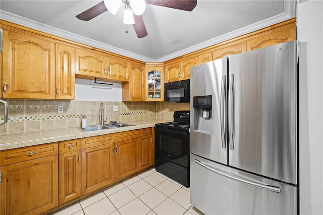 kitchen featuring black appliances, sink, crown molding, tile counters, and light tile patterned floors