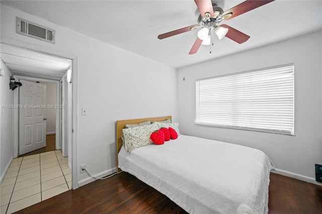 bedroom with ceiling fan and dark wood-type flooring