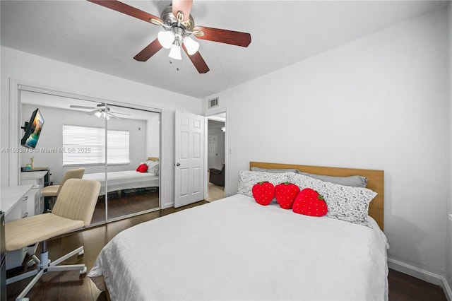 bedroom with ceiling fan, wood-type flooring, and a closet