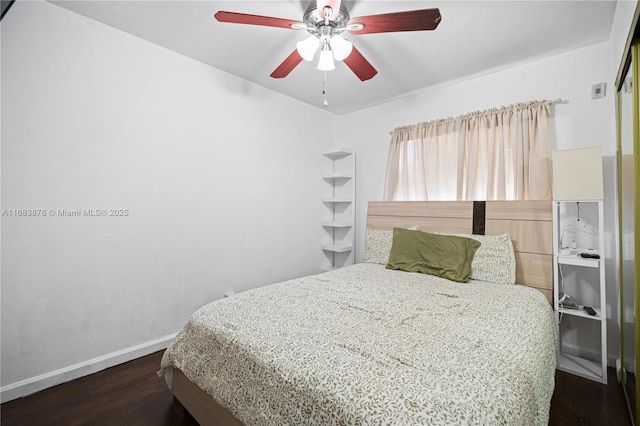 bedroom with ceiling fan and dark hardwood / wood-style flooring