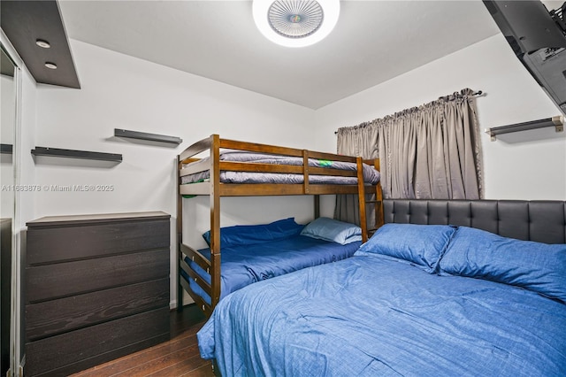 bedroom with dark wood-type flooring