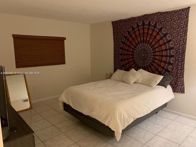 tiled bedroom with a textured ceiling