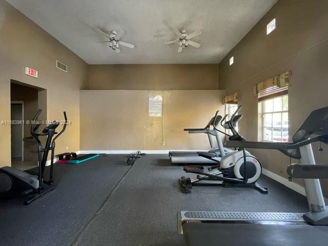 workout area with a textured ceiling and ceiling fan