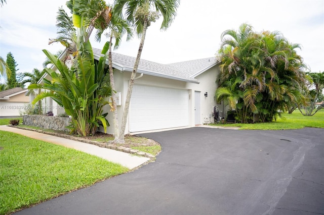 view of front of house with a front yard and a garage