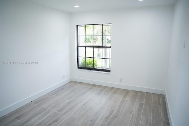 spare room with light hardwood / wood-style flooring