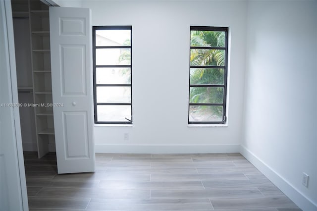 unfurnished bedroom with a closet and light wood-type flooring