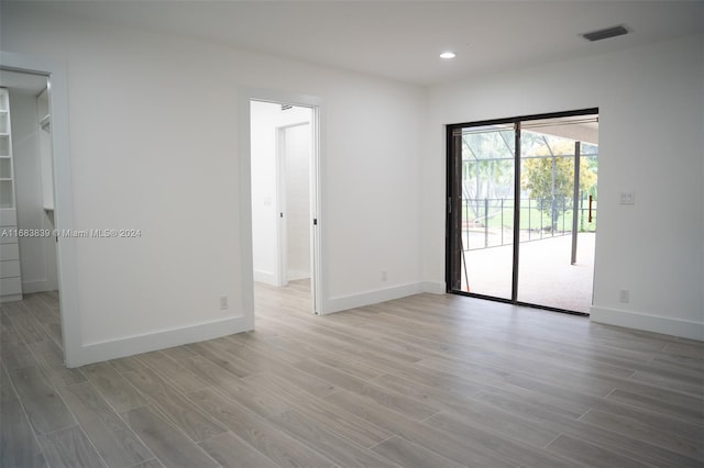 spare room with light hardwood / wood-style flooring