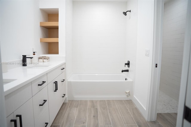 bathroom with vanity and tiled shower / bath combo