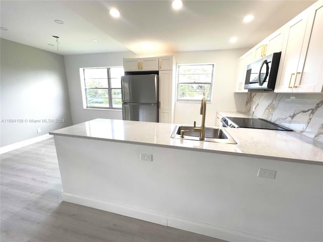 kitchen featuring white cabinetry, sink, a healthy amount of sunlight, and stainless steel appliances