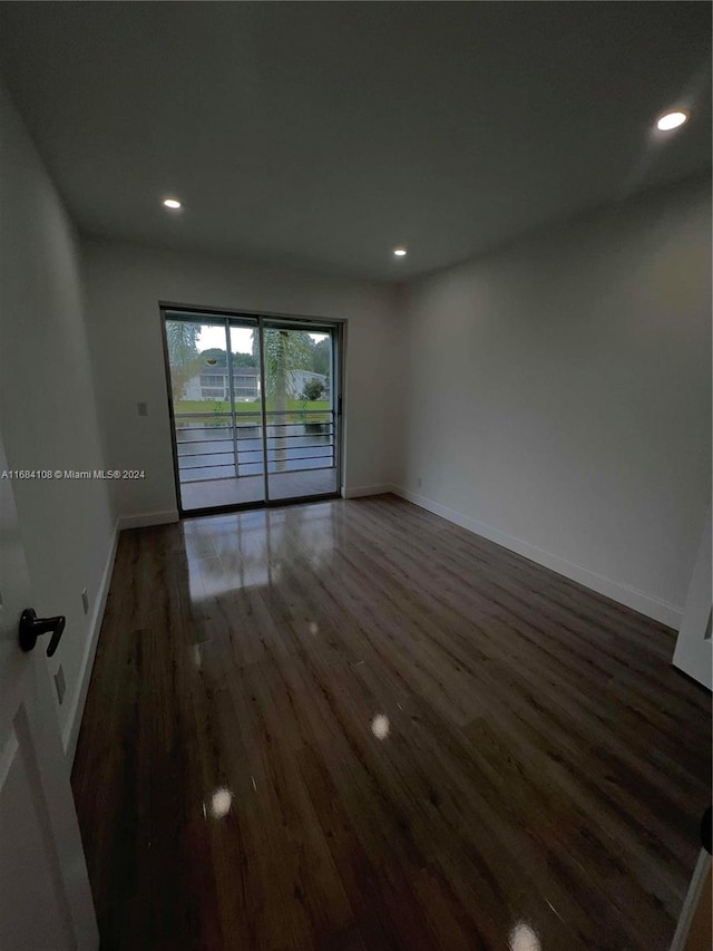 spare room featuring dark hardwood / wood-style flooring