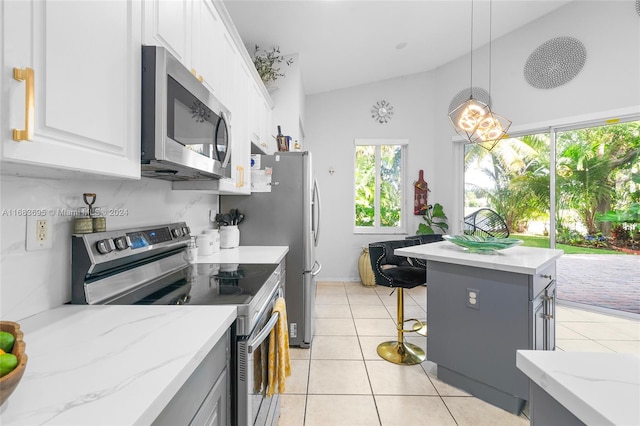 kitchen with gray cabinetry, white cabinetry, ceiling fan, a high ceiling, and pendant lighting