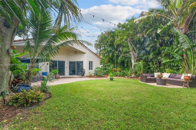 view of yard featuring outdoor lounge area, a patio, and french doors