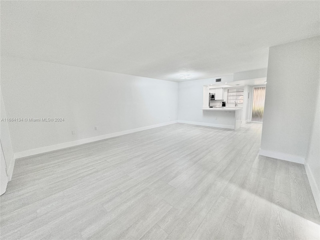 unfurnished living room featuring light wood-type flooring